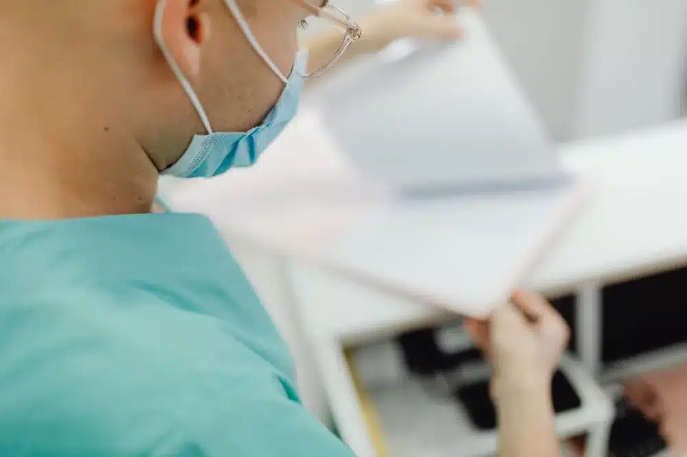 Provider reviewing DOT medical history form with a commercial driver patient