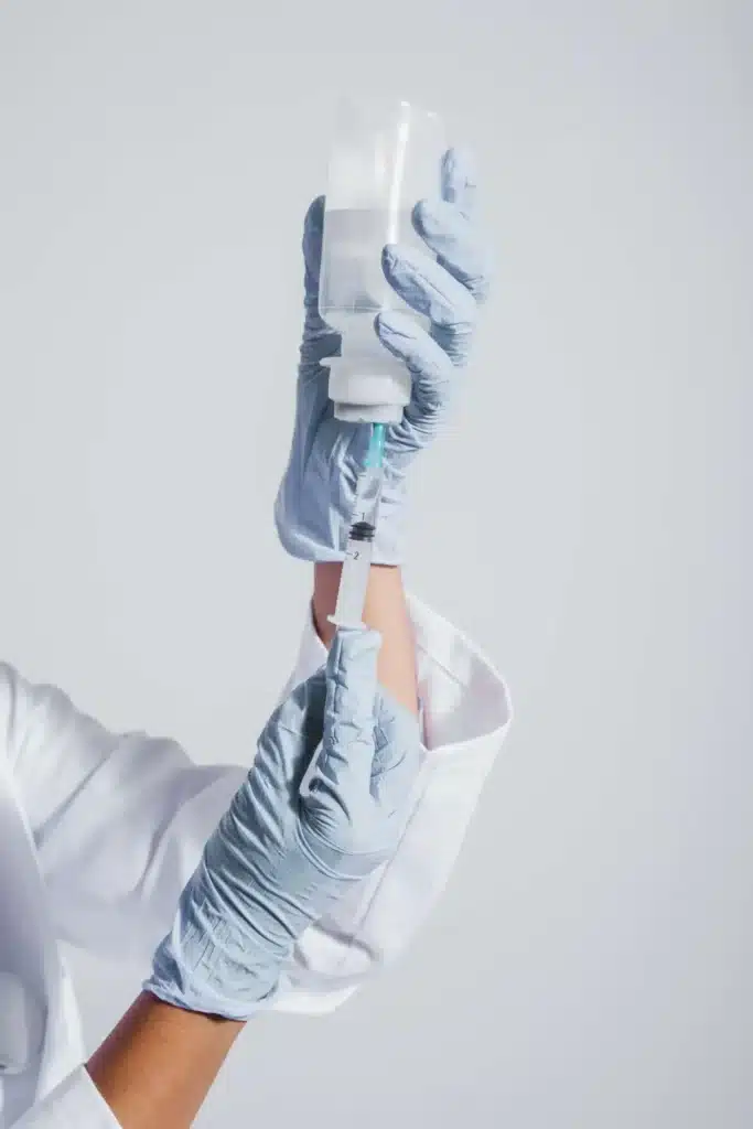 hands with gloves vaccine 1 scaled 1