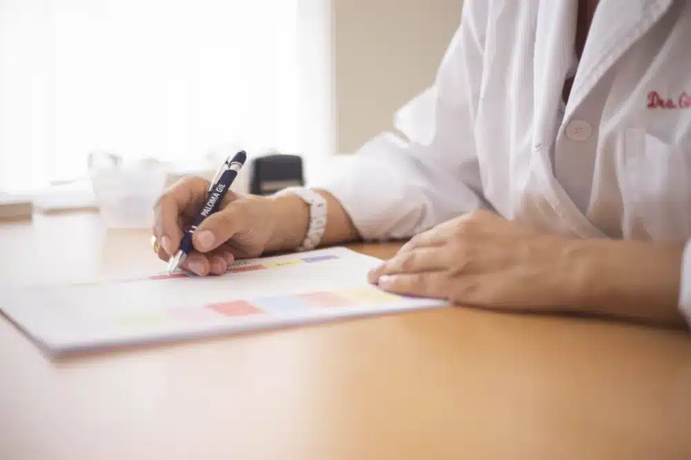 Medical provider reviewing patient intake form at an after-hours urgent care clinic