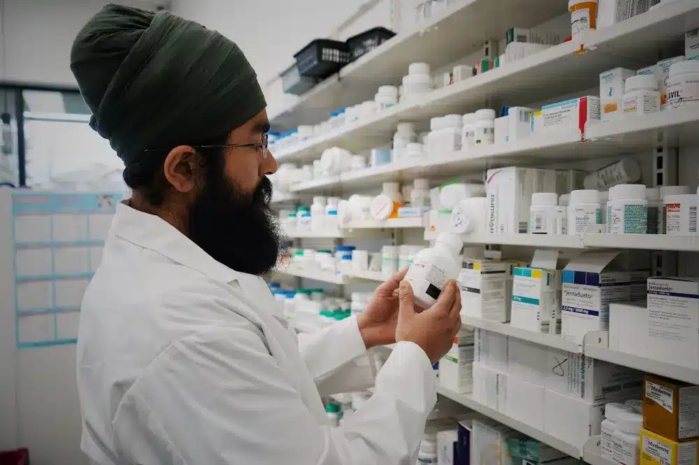 Patient picking up UTI antibiotic prescription at pharmacy after urgent care visit