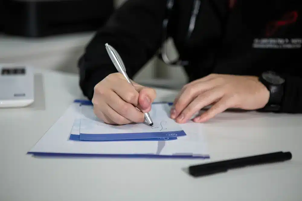 Patient filling out intake paperwork before an orthopedic evaluation at an Arlington urgent care