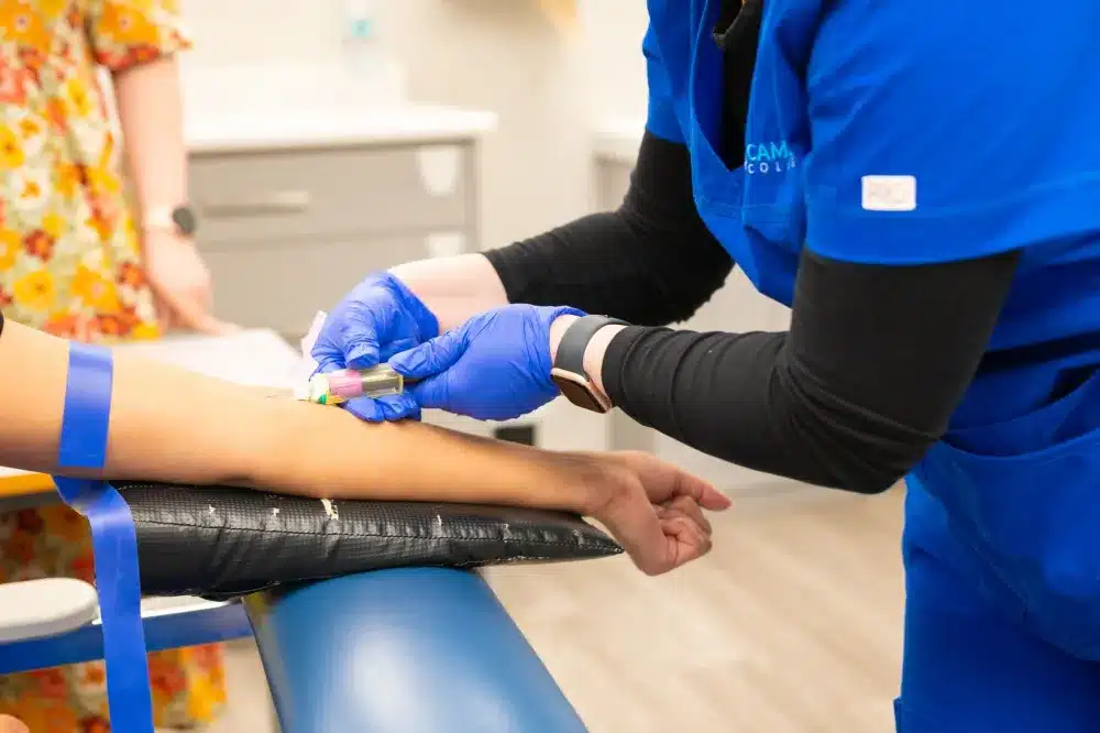 Medical technician drawing blood for routine lab testing at an Arlington TX clinic