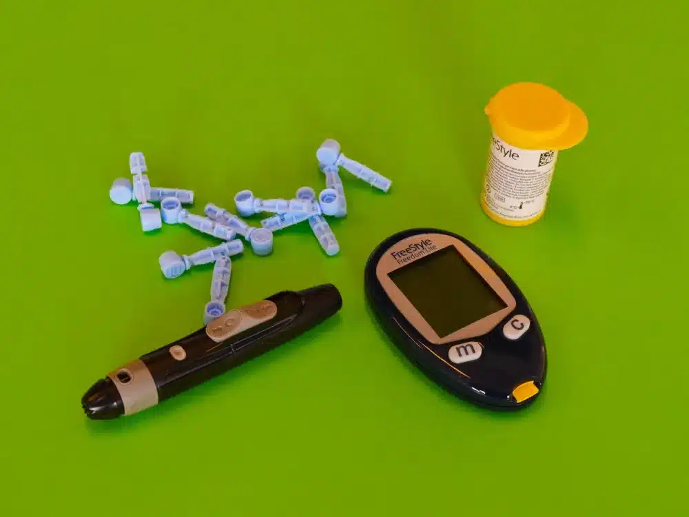 Continuous glucose monitoring device worn by patient managing diabetes with remote care