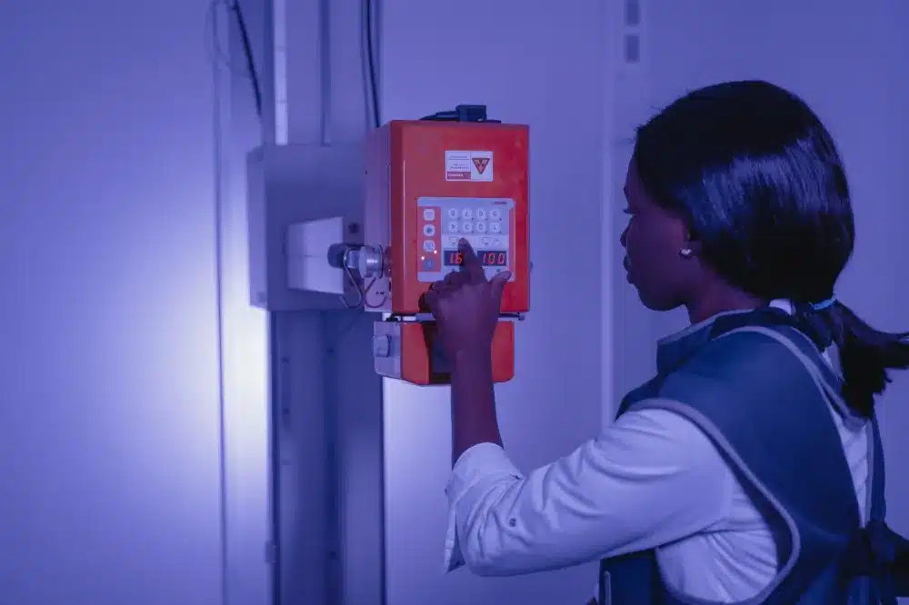 X-ray technician assisting patient at urgent care clinic for same-day imaging