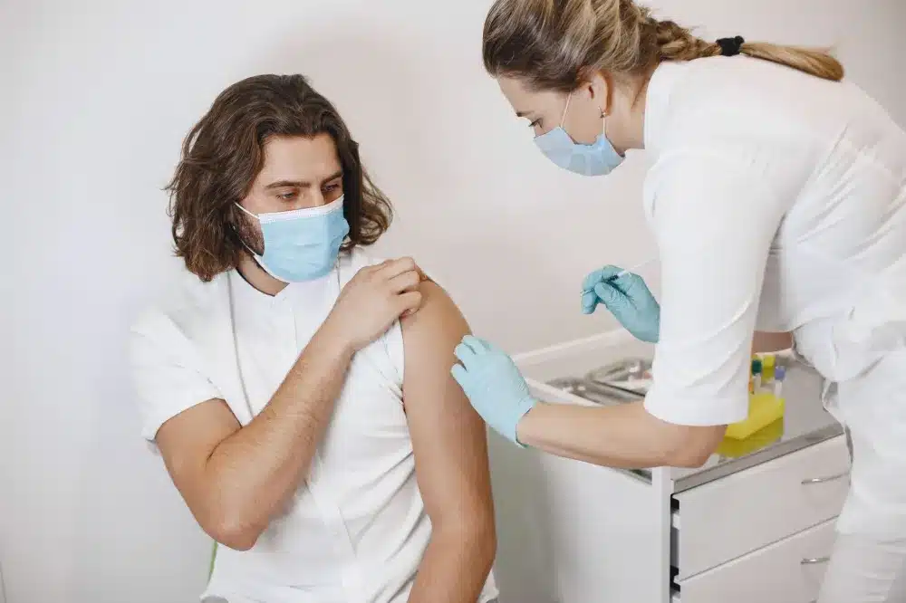 Doctor evaluating a patient with flu symptoms at a walk-in urgent care clinic
