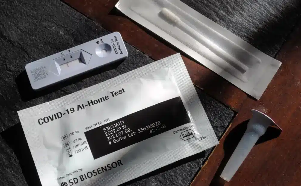Medical professional performing a rapid flu nasal swab test in an urgent care setting