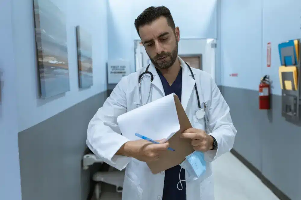 Urgent care provider reviewing digestive health chart with patient at evening clinic