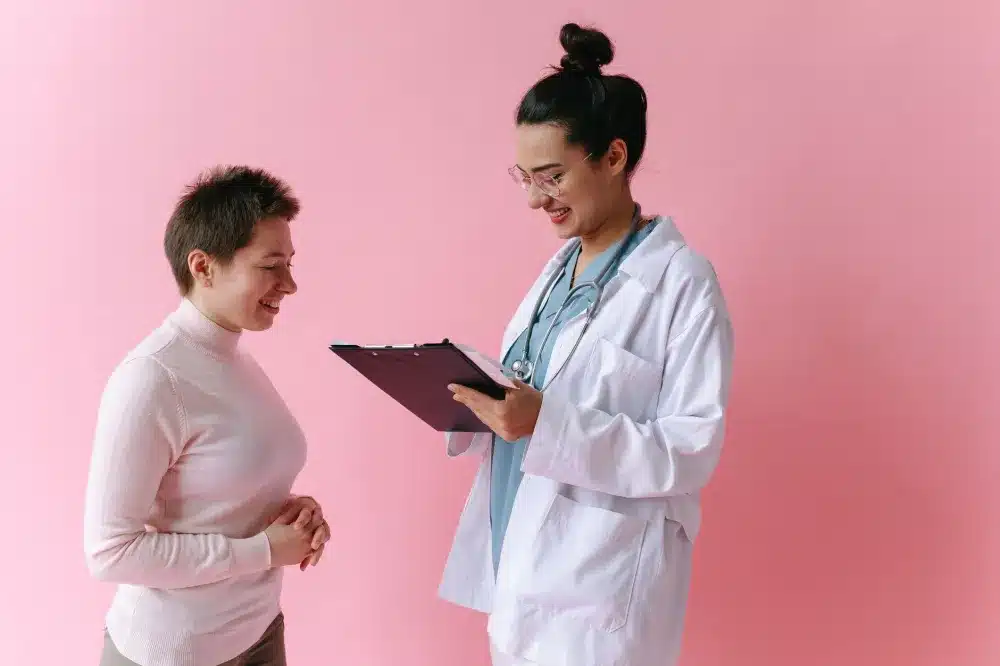 Female doctor reviewing health history with patient during well-woman clinic visit