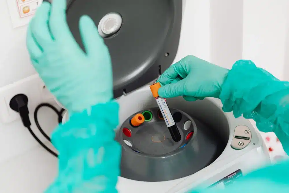 Lab technician processing blood sample for women's health screening tests on site