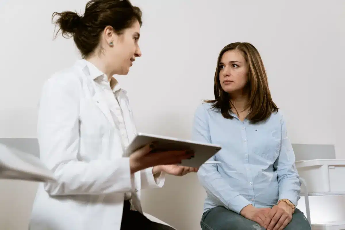 Female provider talking with patient during well-woman exam at women's health clinic in Arlington TX